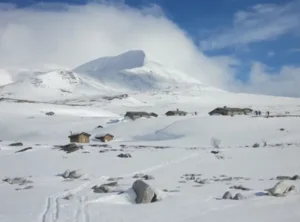 Über der Baumgrenze entfaltet das Fjell im Schnee seine ganze. Weite besonders bei bedecktem <Himmel mit Wolken